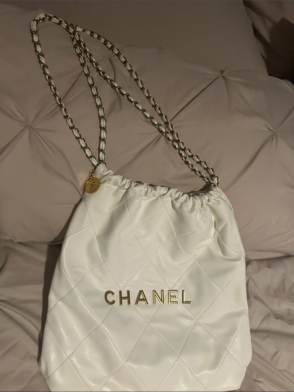 White Quilted Drawstring Shoulder Bag with Gold Chain Trim